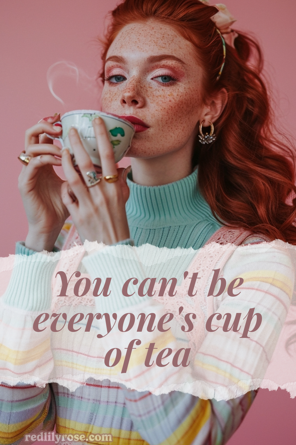 A woman with radiant red hair and a constellation of freckles, sips elegantly from a delicate teacup, her green eyes reflecting a quiet confidence. Her pastel sweater and the soft pink backdrop highlight her porcelain skin, while a dainty hair bow adds a touch of whimsy. A text overlay reads, "You can't be everyone's cup of tea."